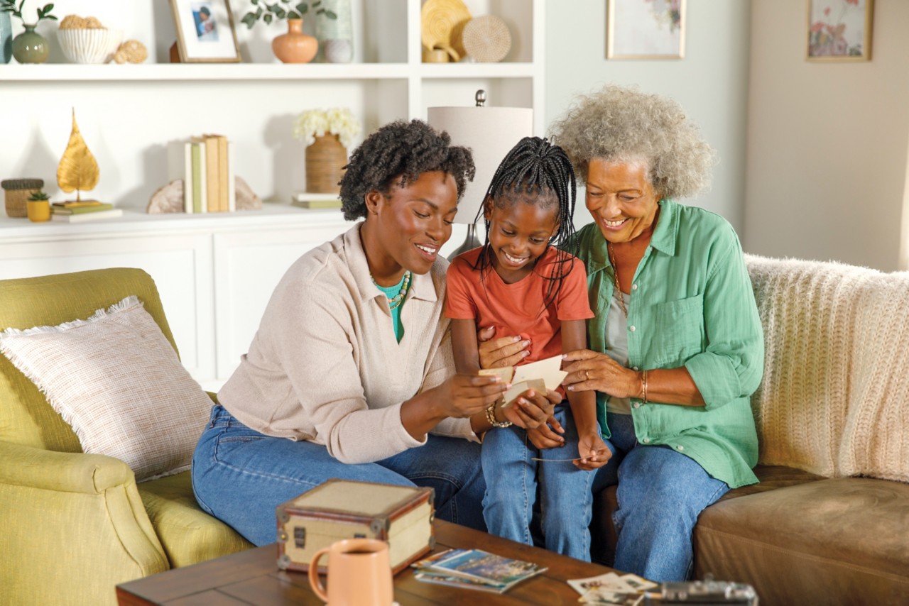 Mother, Grandmother and Grandaugther looking at photos